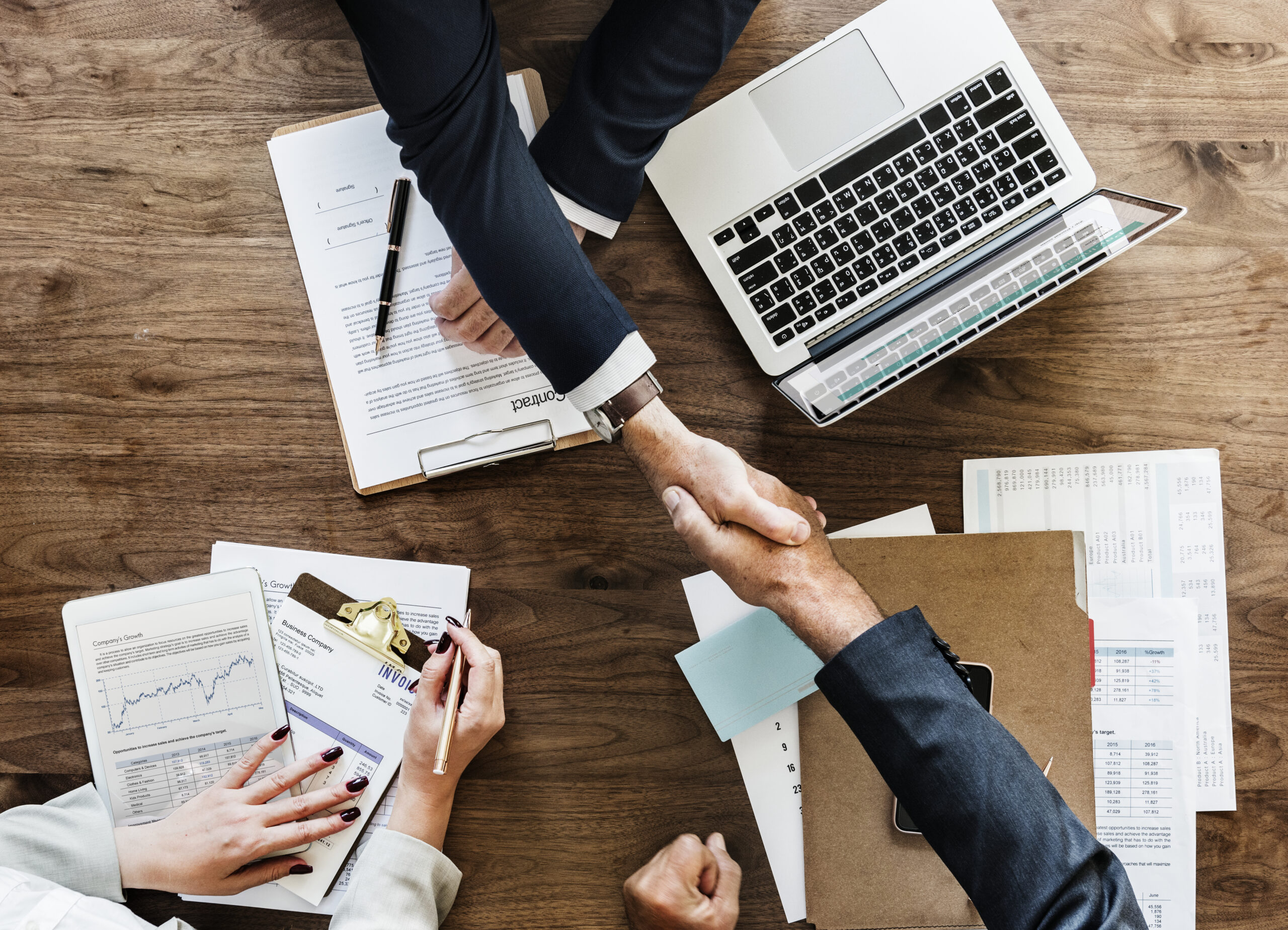 A collaboration scene with documents and teamwork around a meeting table